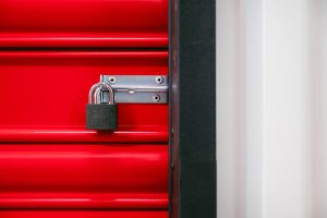 secure shed with metal door lock and motion light outside at night